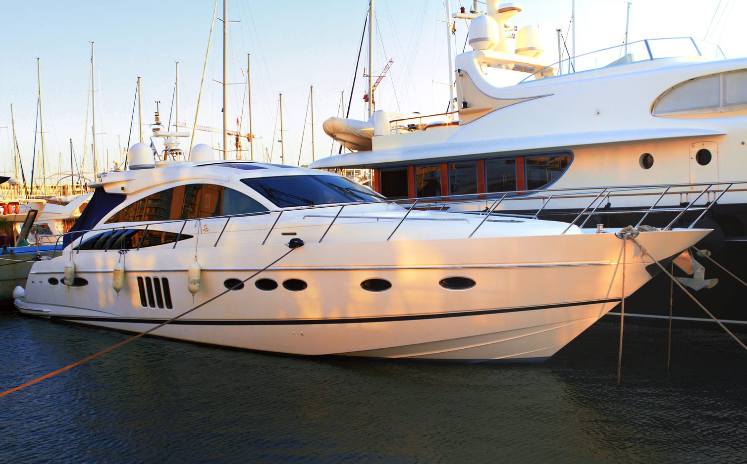 A yacht is at a marina near Ozark Grease Pros in Siloam Springs, showing a clean setting and busy boating area.