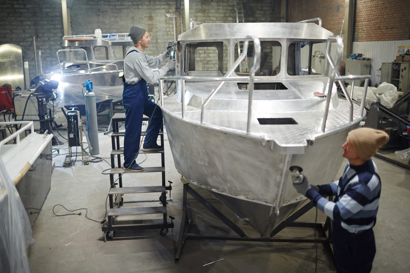Two workers team up on boat prep, showing how Ozark Grease Pros’ teamwork keeps kitchens working smoothly.