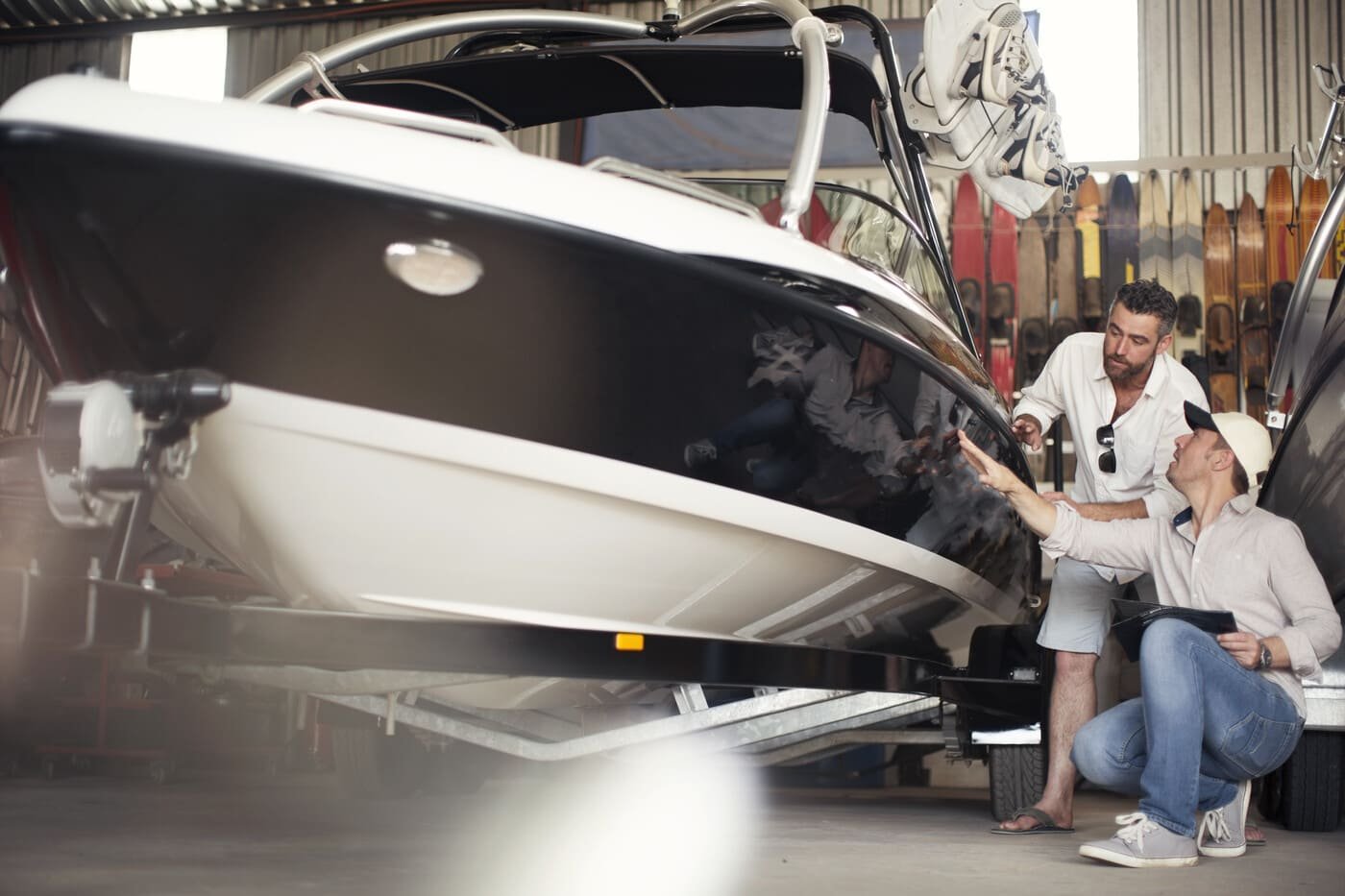 Two men carefully check a boat, showing the careful service Ozark Grease Pros gives for grease trap cleaning.