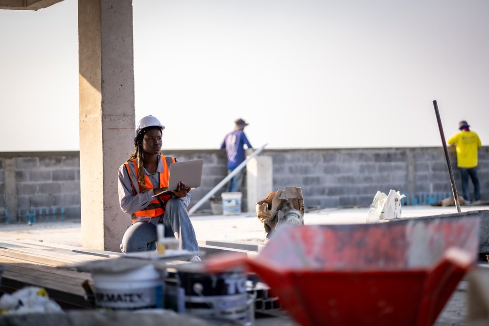 Ozark Grease Pros worker uses a laptop at a job site, planning grease trap pumping in northwest Arkansas.